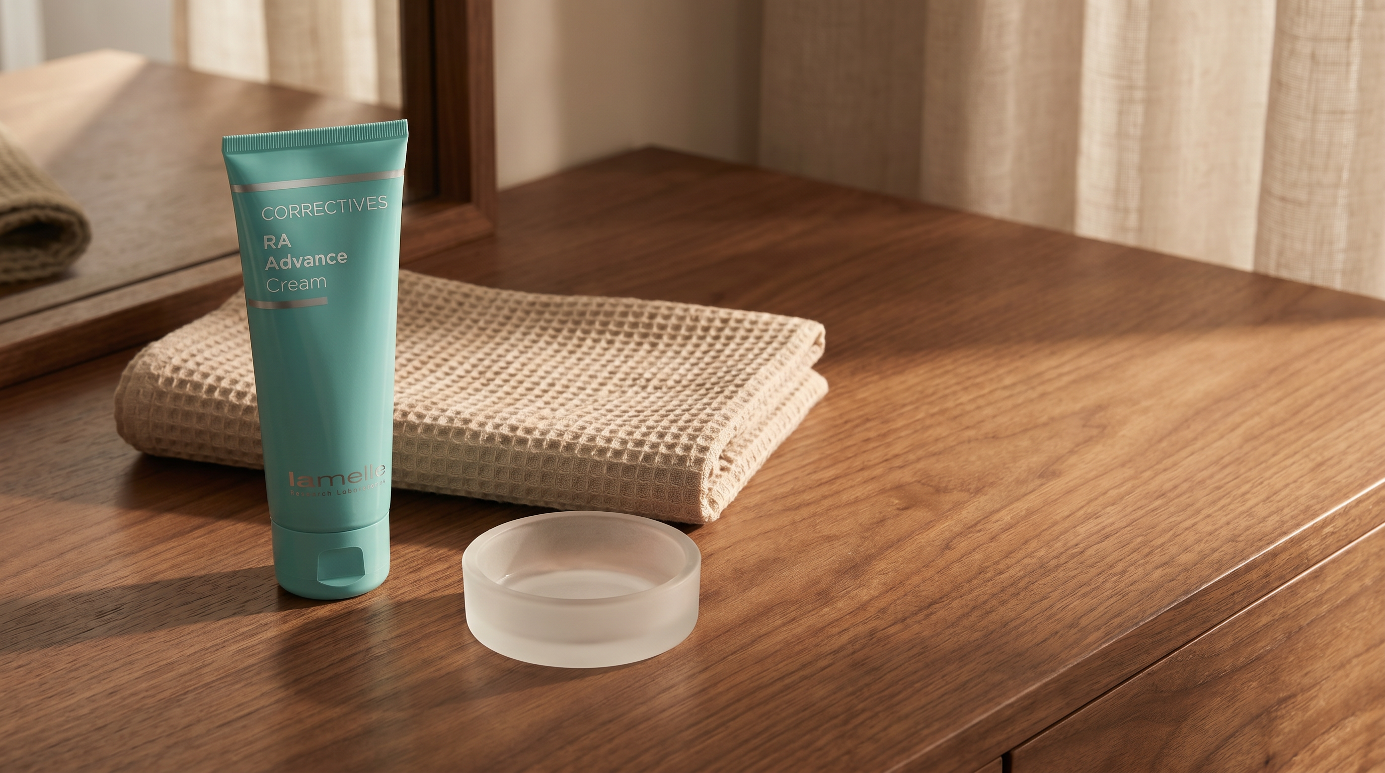 Lamelle RA Advance Cream on a warm walnut wood vanity beside a folded waffle cloth in soft evening light
